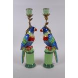 A pair of polychrome porcelain and gilt metal parrot candlesticks, 32cm high