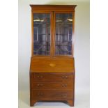 A Victorian mahogany bureau bookcase with a astral glazed top, the fall front fitted with pigeon