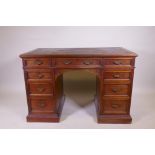 A fine quality solid walnut kneehole desk with inset gilt tooled leather top stamped Howard &