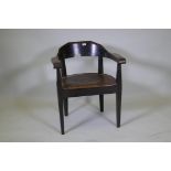 A late C19th/early C20th German oak tub chair with leather studded seat