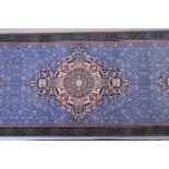 An Iranian fine woven blue ground runner with a medallion design surrounded by an embossed all