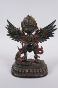 A Tibetan bronze figure of Garuda with painted and gilt details, 18cm high