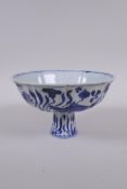A blue and white porcelain stem bowl of lobed form, decorated with carp in a lotus pond, Chinese
