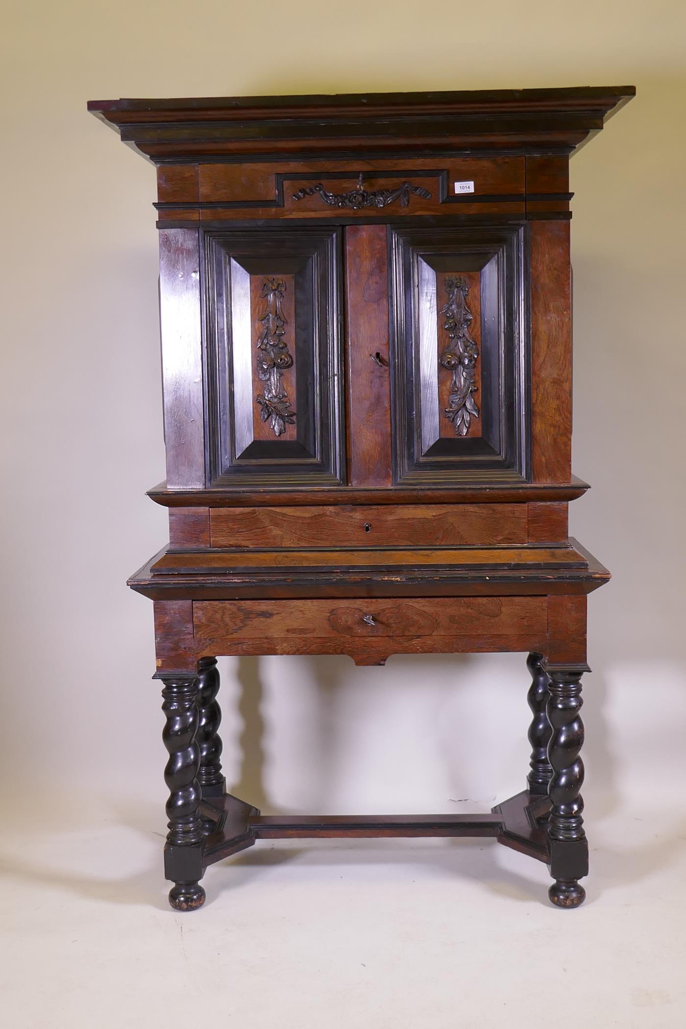 A C19th Continental rosewood cabinet on stand, with carved and ebonised detail, the upper section