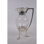 A Christopher Dresser style silver plate and glass claret jug, 26cm high