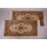 A pair of gold ground Kashmir runners with a floral medallion design, 142 x 68cm
