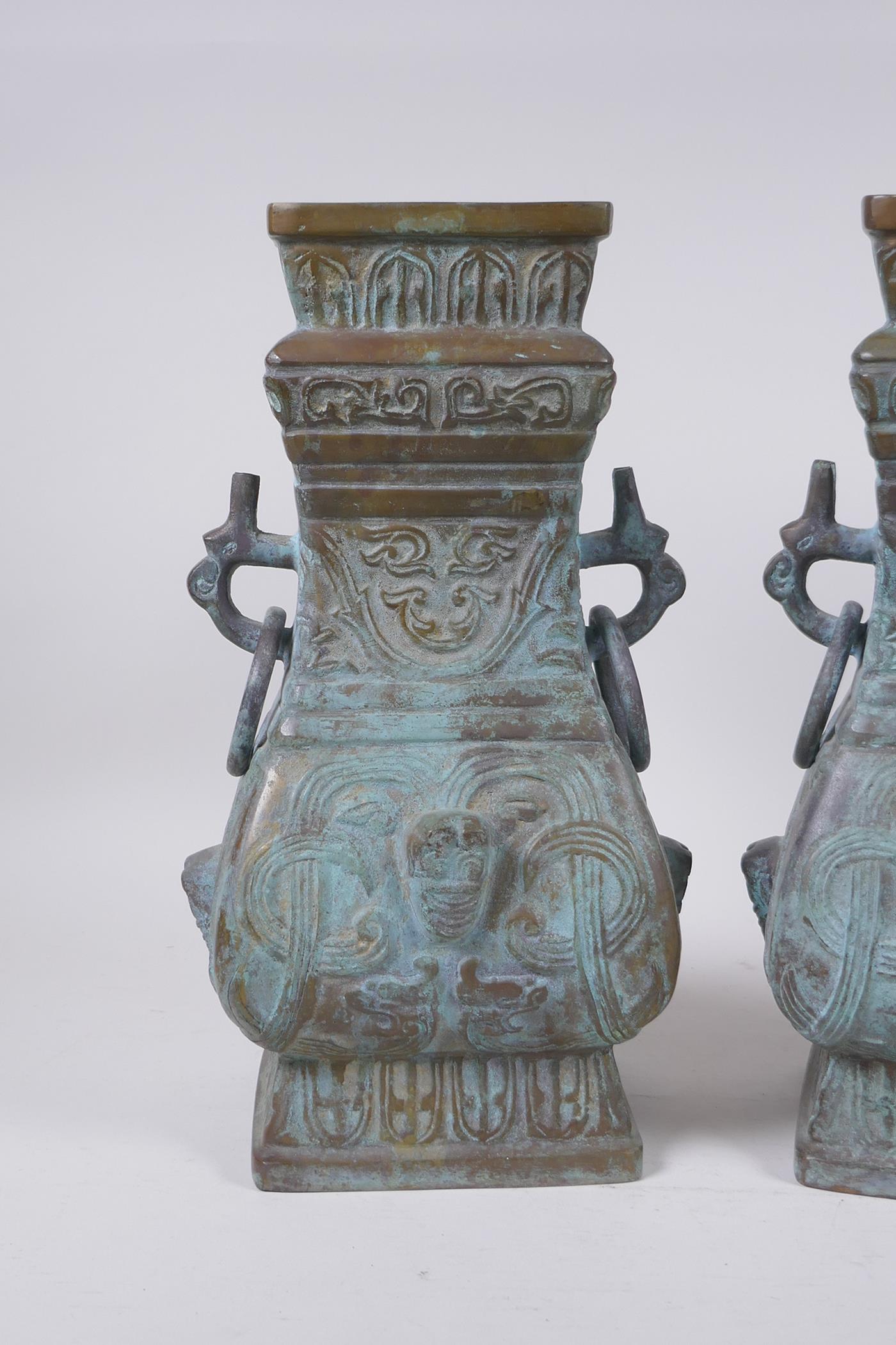 A pair of Chinese archaic style bronze vases with two dragon loop handles, lack bases, 32 cm high - Image 2 of 4