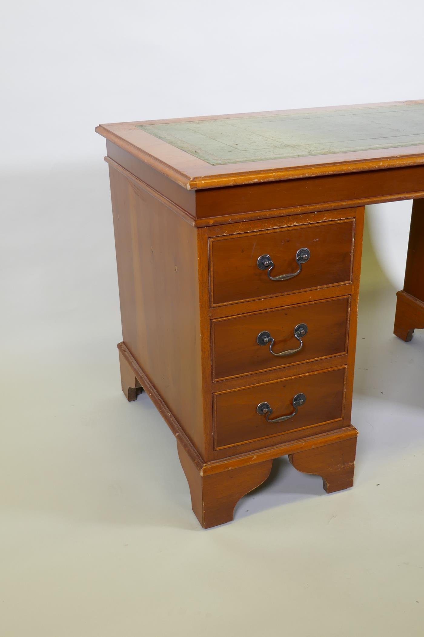 A yew wood five drawer pedestal desk with leather inset top, raised on bracket supports, 122 x 61 - Image 3 of 4