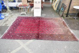 A hand woven wool Bokhara carpet, faded one end, 200 x 300cm