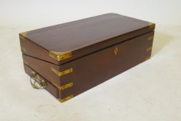 A C19th mahogany writing slope with military style brass mounts and a removable book stand, 55 x
