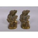 A pair of brass bookends with pine cone decoration, marked PMC 86, 14cm high