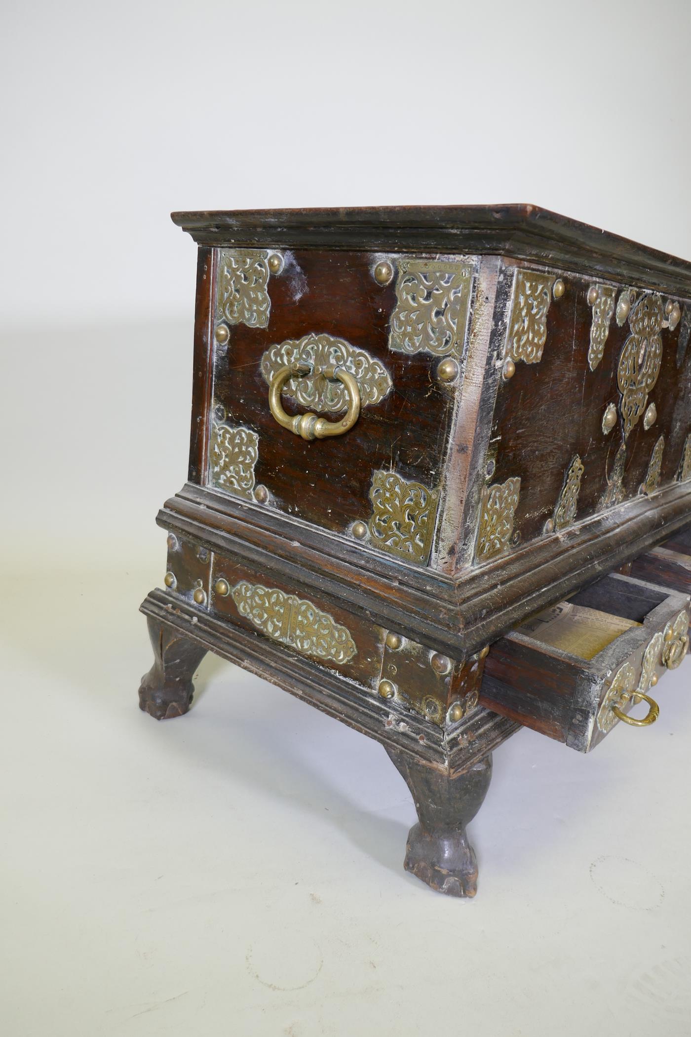 An C18th Dutch colonial teak chest with brass mounts, lift up top and two drawers, raised on claw - Image 6 of 8
