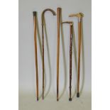 Three horn handled walking sticks including one with a silver mount, and two other wood walking