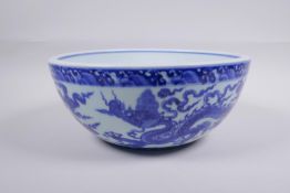 A blue and white porcelain bowl decorated with dragons in flight, Chinese Xuande 6 character mark to