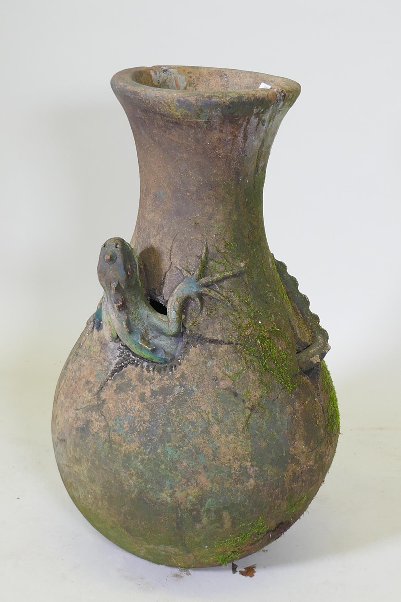 A terracotta garden vase with an applied and painted lizard, historic repair, 66cm high