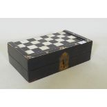 A C19th ebony and ivory and stained bone games box, with chequer board top and backgammon