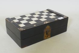 A C19th ebony and ivory and stained bone games box, with chequer board top and backgammon