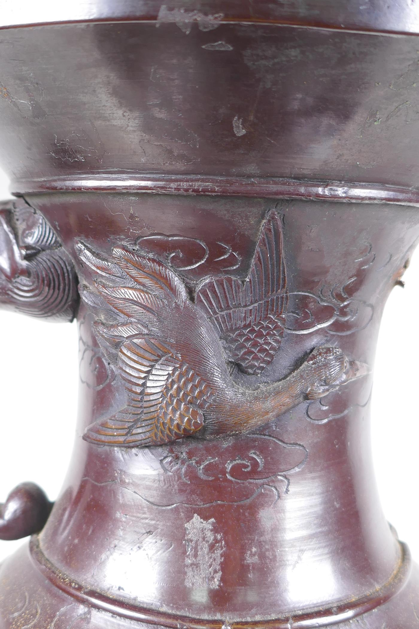 A Japanese Meiji period bronze urn with two handles and raised decorative panels depicting asiatic - Image 3 of 9