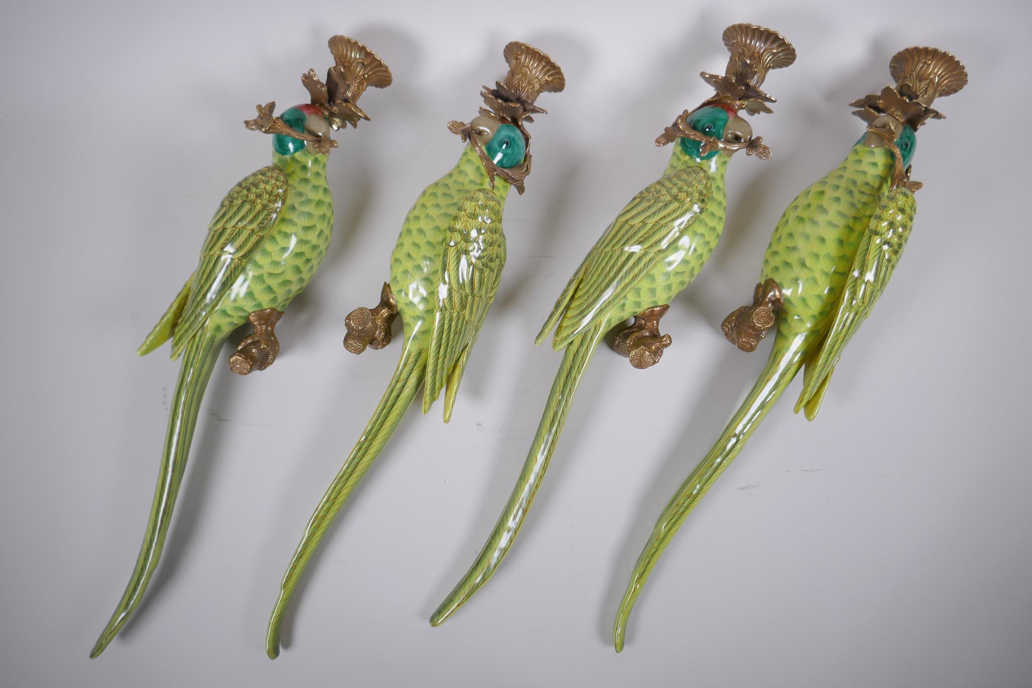 Two pairs of polychrome porcelain and gilt metal parrot sconces, 47cm long
