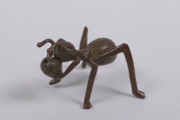 A Japanese style bronze okimono ant incense stick holder, indistinct mark to base, 5cm long