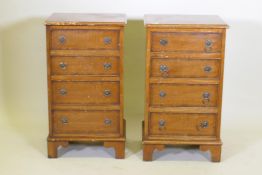 A pair of mahogany side chests of four graduated drawers with banded inlay, raised on bracket