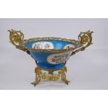 An ormolu mounted Sevres style porcelain centrepiece with decorative panels depicting a courting