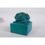 A Chinese reconstituted turquoise blue hardstone seal with a twin headed mythical creature knop,