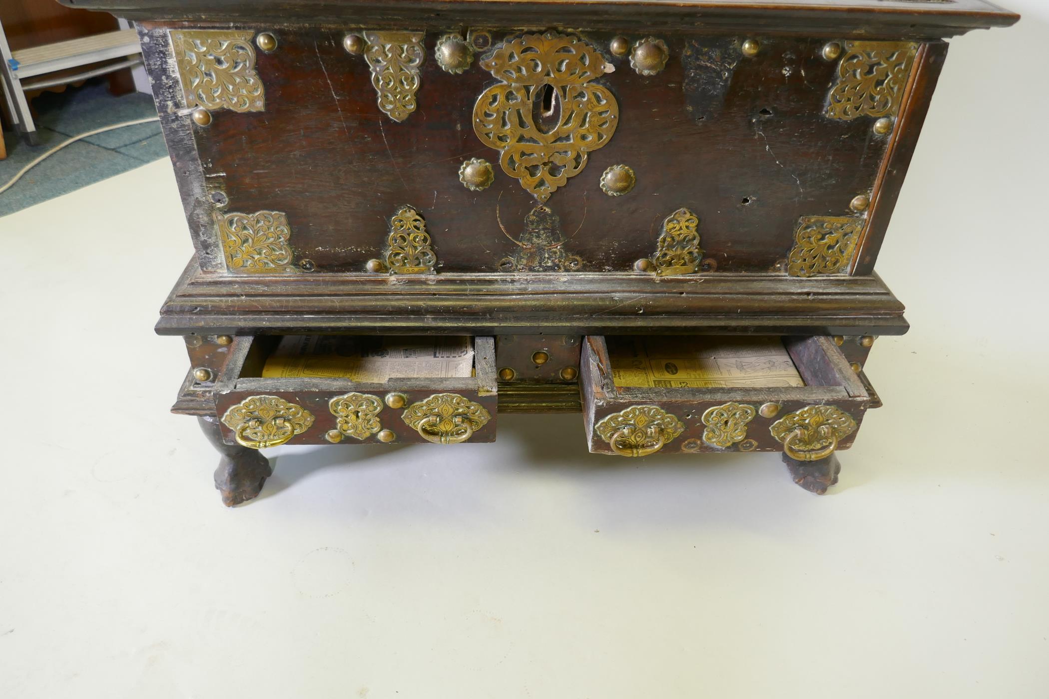 An C18th Dutch colonial teak chest with brass mounts, lift up top and two drawers, raised on claw - Image 5 of 8