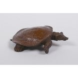 A Japanese style bronze okimono tortoise, seal mark to base, 9cm long