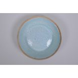 A Chinese celadon glazed porcelain dish with underglaze carp decoration, 13cm diameter