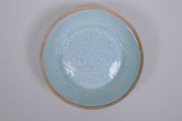 A Chinese celadon glazed porcelain dish with underglaze carp decoration, 13cm diameter