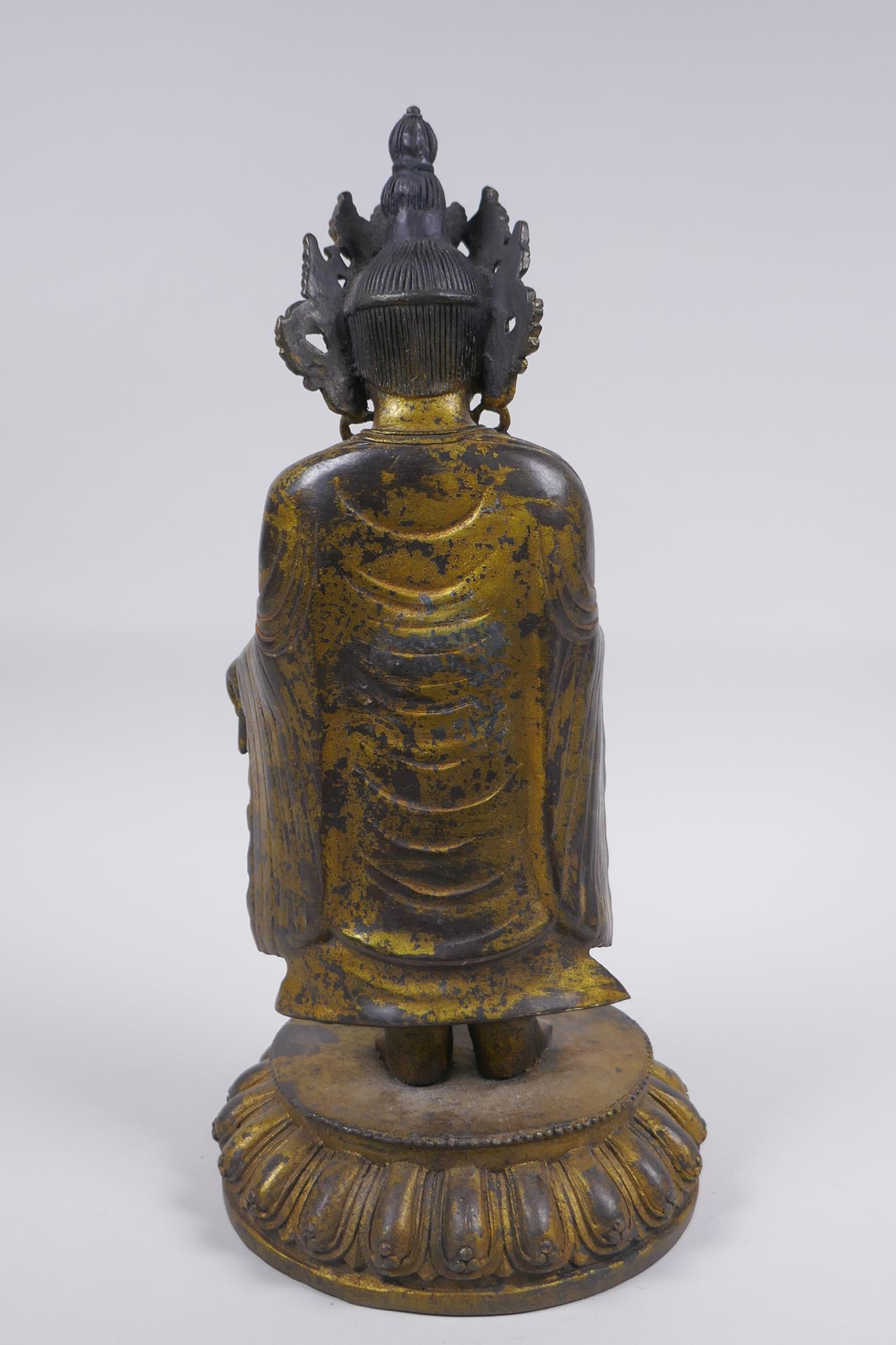 A Sino Tibetan gilt bronze figure of Buddha standing on a lotus flower, 32cm high - Image 4 of 6