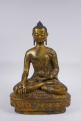 A Sino Tibetan filled gilt bronze figure of Buddha, impressed double vajra mark to base, 30cm high