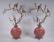 A pair of polychrome porcelain and gilt metal pricket candlesticks decorated with song birds perched