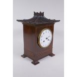 A C19th/early C20th French mahogany cased mantel clock in the Chinese Chippendale style, the