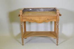 A continental elm single drawer wash stand with fitted marble three quarter gallery, raised on