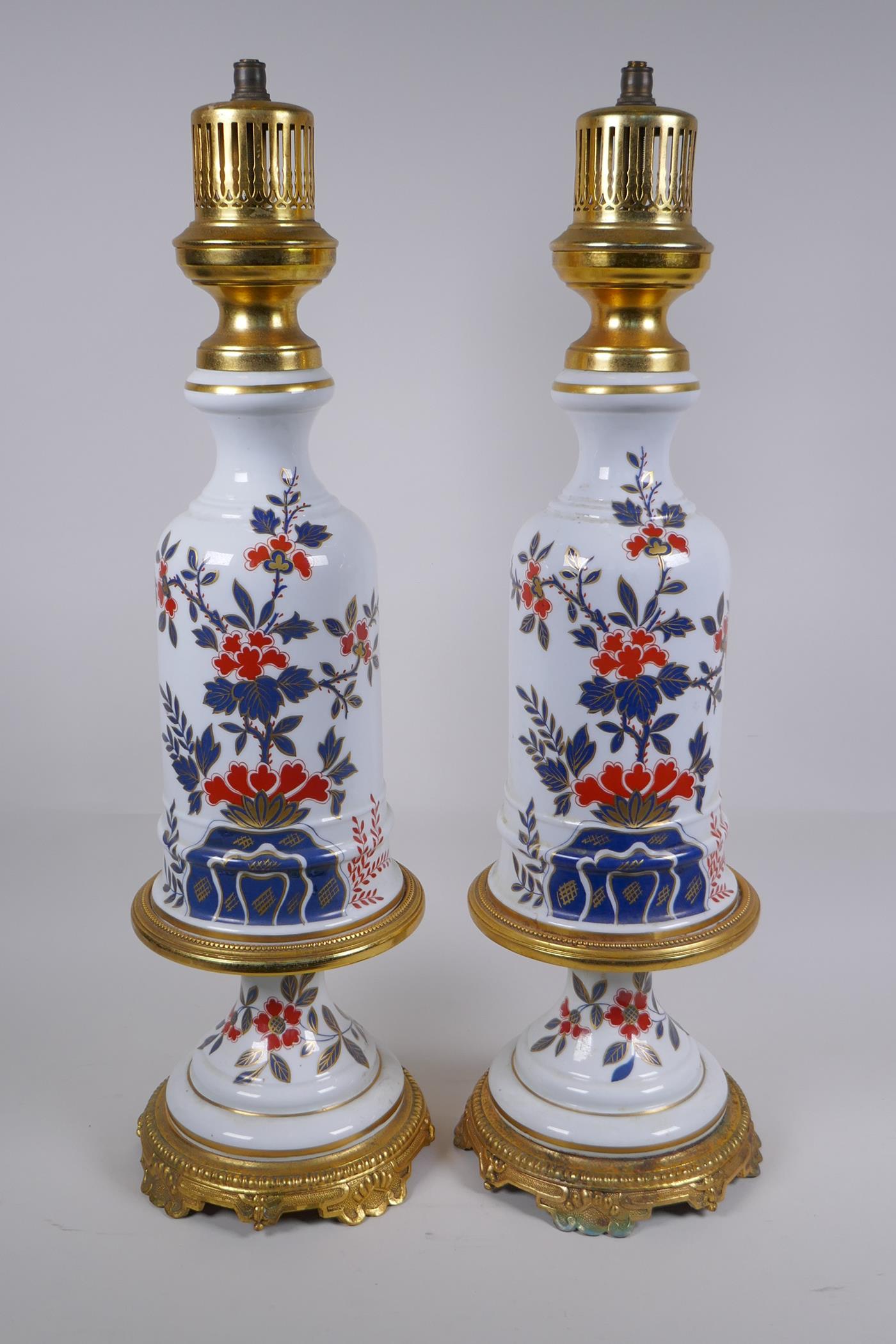 A pair of ormolu and porcelain lamp bases with Imari style decoration, 59cm high