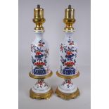 A pair of ormolu and porcelain lamp bases with Imari style decoration, 59cm high