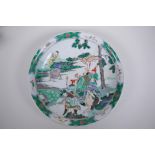 A Chinese KangXi style famille verte porcelain charger decorated with figures in a landscape, 29cm