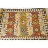 A woven wool kilim rug with geometric designs, 160 x 230cm