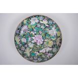 A Chinese famille noir porcelain dish decorated with asiatic flowers, YongZheng 6 character mark