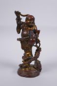 A Chinese gilt and coppered bronze figure of Lohan, 16cm high