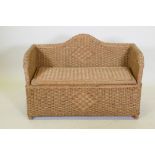 A wicker ottoman with lift up seat, 96 x 67cm high