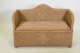 A wicker ottoman with lift up seat, 96 x 67cm high