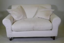 A Habitat two seater sofa with cream coloured linen covers, 140cm wide