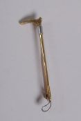 A 15ct gold and white metal riding crop brooch, 3g gross, 5cm