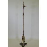 An antique bronze and ormolu standard lamp with Empire style decoration and triform base, 168cm high