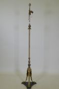 An antique bronze and ormolu standard lamp with Empire style decoration and triform base, 168cm high