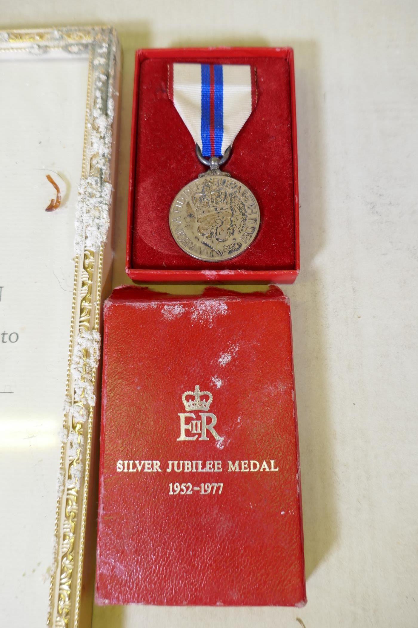 An Elizabeth II Silver Jubilee medal with ribbon in original case, with citation - Image 2 of 3