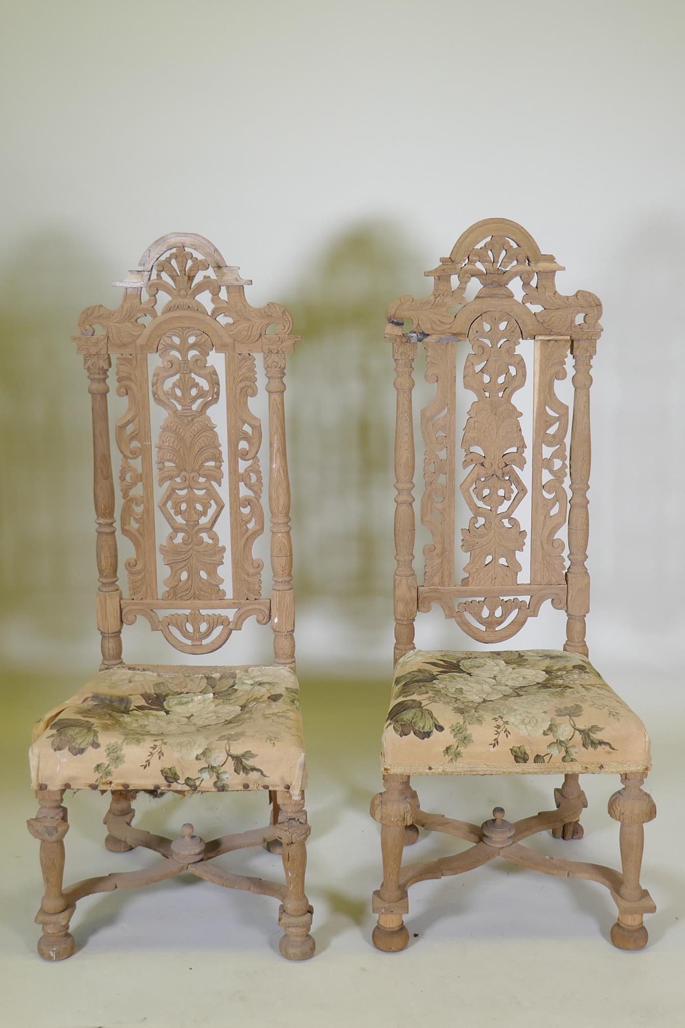 A pair of French C19th oak high back chairs with carved and pierced backs, 128cm high, AF